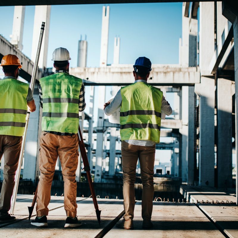 Construction engineers discussion with architects at construction or building site